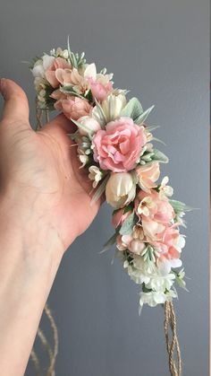 a hand holding a bouquet of flowers in it's left hand and another photo of the same flower