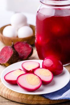 sliced radishes sit on a plate next to a jar of water and eggs