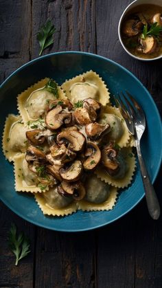 a blue plate topped with ravioli and mushrooms