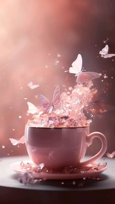 a cup filled with liquid and butterflies flying out of it