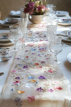 the table is set with glasses and plates