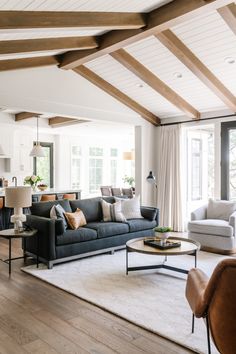 a living room filled with furniture and lots of windows