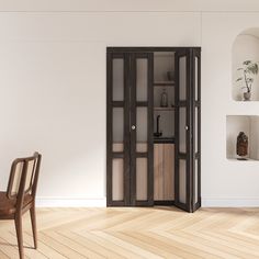 an empty room with a chair, table and bookcase on the floor in front of it