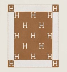 a brown and white rug with the letter h on it's center square shape