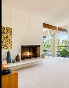 a living room with a fireplace and large windows