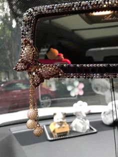 the rear view mirror of a car with beads hanging from it