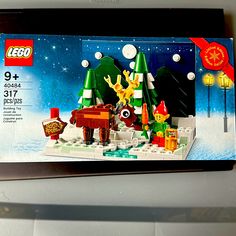 a lego christmas scene is shown in the box