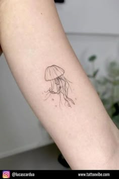 a small jellyfish tattoo on the arm