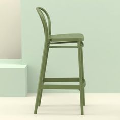 a green chair sitting in front of a wall