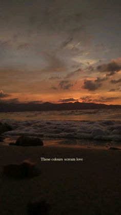 the sun is setting at the beach with waves coming in to shore and clouds above