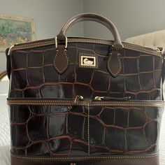 Great Condition Satchel. Very Minimally Used Beautiful Dooney And Bourke Croc Embossed Leather Handbag. Brown With Gold Tone Hardware. Pink Canvas Interior. Measurements Are 14.5" From Side To Side At Widest Point, 11" X 6.5" Across The Bottom And 10" From Center Bottom To Top. Interior Measurements, Pink Canvas, Dooney And Bourke, Dooney & Bourke Bags, Dooney & Bourke, Handbag Purse, Leather Handbag, Dooney Bourke, Brown Gold