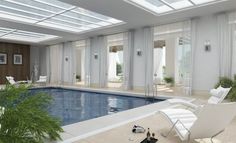 a large indoor swimming pool with sunroof and lounge chair next to the pool