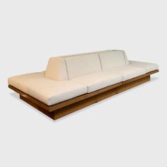 a white couch sitting on top of a wooden table