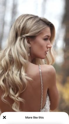 the back of a woman's head with long blonde hair, wearing a wedding dress