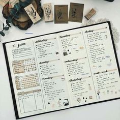 an open planner with stamps on it next to some flowers and other things in the background