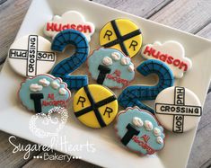 decorated cookies are arranged on a plate with the numbers two and four in different colors