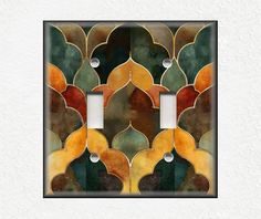 a decorative light switch plate cover with an art deco design