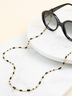 Get ready to turn heads with the stunning Ginny Sunglass strap. The combination of black and golden in your Sunny Cord is as essential as tonic to your Gin. Go add your black blazer or your fav blouse. You are never overdressed and underdressed with this one. Not in need to hold the glasses? Detach the rubbers and wear it as a bracelet or necklace! PRODUCT FEATURES ✓ Length: 72 cm ✓ Material: Stainless steel with gold or silver plating, extra coated ✓ Lightweight for comfortable wear ✓ High Qual Rose Gold Fabric, All European Countries, Kinds Of Shapes, Gold Fabric, Sunglasses Shop, Classic Collection, White Beads, Beaded Chain