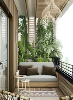 an outdoor living area with wicker furniture and plants on the roof deck, surrounded by greenery