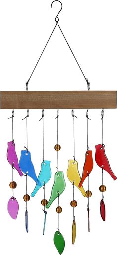 a colorful wind chime hanging from a wooden beam with birds on it's hooks