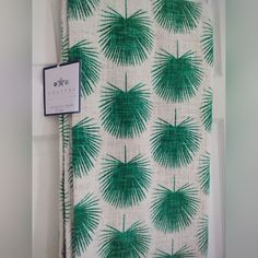 a green and white wall hanging on the side of a door