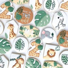 the cookies are decorated with jungle animals and leaves