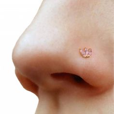 a woman's nose with a small pink diamond on it