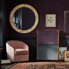 a chair and mirror in a room with purple walls