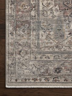 an area rug on top of a wooden floor with a brown and white color scheme