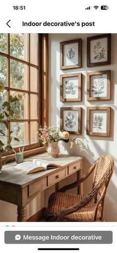 an image of a desk with pictures on the wall and flowers in vase next to it