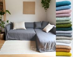 a living room filled with lots of pillows and blankets on top of a white rug