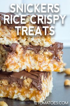 two pieces of snickkers rice crispy treats stacked on top of each other