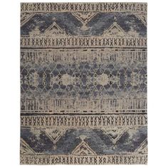 a blue and beige rug with an intricate design on the bottom, in front of a white background