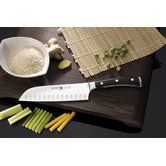 a knife and some vegetables on a cutting board