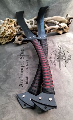 two large black and red knives on top of each other