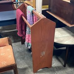 a wooden podium sitting in the middle of a room filled with chairs and bookshelves