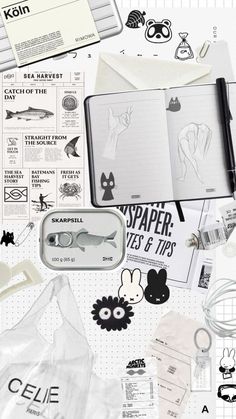 an open notebook surrounded by stickers and other items