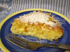 a piece of pie on a blue and yellow plate with a fork next to it