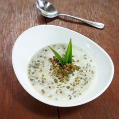 a white bowl filled with oatmeal on top of a wooden table