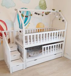 a child's bedroom with a white bunk bed and stairs leading up to it