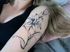 a woman with a flower tattoo on her arm