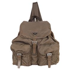 Authentic, pre-owned Prada Tessuto brown nylon drawstring backpack. This backpack features a nylon body, drawstring and buckle closure, flat back straps, drawstring closure, and exterior buckle pockets. Made in Italy 11.5"L x 6"W x 11"H Condition Gently Used Exterior scuffs or marks. The straps are strong at the base, light fading, normal leather aging, all grommets are secure and in place, all closures work properly. Great condition backpack! Please look at every detail of the photos. Use the e Leather Formal Shoes, Archive Fashion, Bag Packaging, Work Bag, Backpack Purse, Back Strap, High Quality Leather, Leather Material, Fashion Handbags