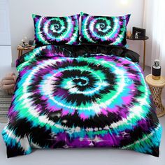 a bed covered in a colorful comforter and pillows