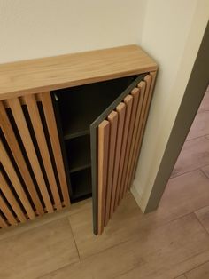 a wooden radiator next to a white wall