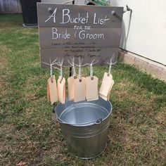 a bucket list for the bride and groom on display in front of a sign that says, a bucket list to the bride and groom