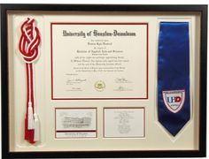 a diploma certificate with a red and white tassel hanging from it's side