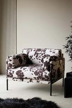 Lifestyle image of the Rockett St George Cowhide Patterned Armchair styled in a neutral room alongside a black rug, furniture and plant. Cow Chair Living Room, Cow Print Furniture, Animal Print Accent Chair, Cow Print Chair, Printed Accent Chairs, Print Armchair, Chic Accent Chairs, Cowboy Culture, Western Gothic