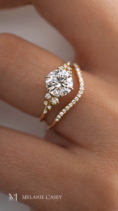 a woman's hand with a diamond ring on it