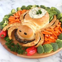 a plate that has some food on it with vegetables and other things in the shape of a spider