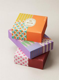 three colorful boxes stacked on top of each other